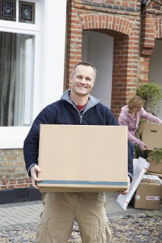 A professional man loading items into a moving truck