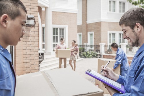 Professional movers packing items in a Haringey home
