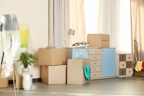 Professional movers handling furniture in Becontree