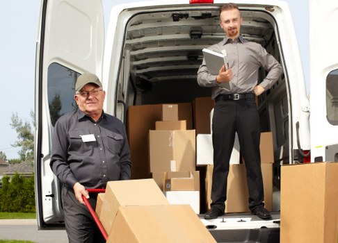 Professional removals man with van assisting in a commercial move.