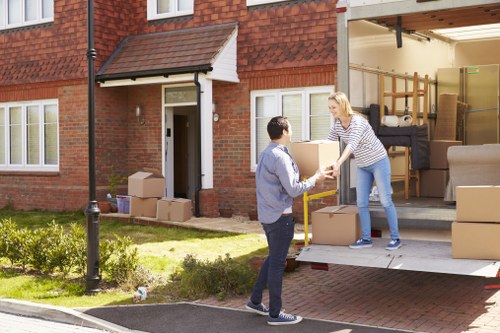 Man with van efficiently loading packed boxes